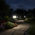 Several solar spotlights lighting a garden path at night