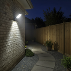 Sentry solar security light illuminating a back garden path