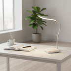 Stem LED desk lamp on a minimalist white desk in morning light