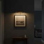 Gallery cordless picture light above a framed print in a hallway