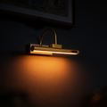 Aurevia Gallery cordless picture light glowing warm at night