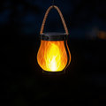 Aurevia Ember solar flame lantern glowing at night