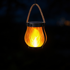 Aurevia Ember solar flame lantern glowing at night
