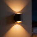 Aurevia Twin cordless LED wall sconce washing a bedroom wall with warm light from both ends at night
