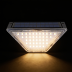 Single solar step light on black, showing the polysilicon panel and the trapezoid lens packed with 24 warm white LEDs