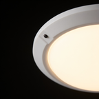 Close detail of the Orbit ceiling light's white rim and infrared sensor bead