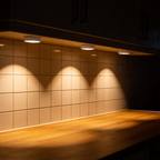 Tread puck lights under kitchen wall cabinets, lighting the splashback and worktop