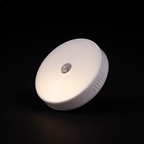 Close detail of a single Tread puck light showing its white face and infrared sensor bead