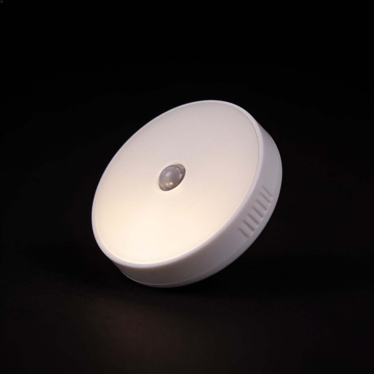 Close detail of a single Tread puck light showing its white face and infrared sensor bead